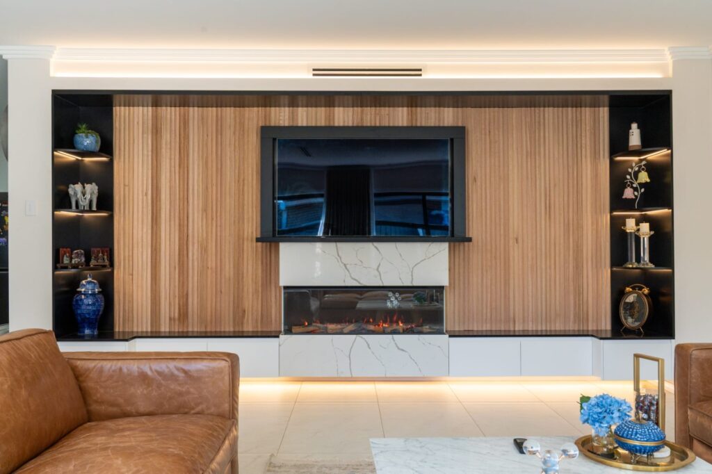 Living room renovation with built-in gas fireplace, timber slat feature wall and LED shelving